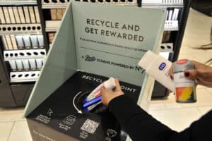 Products being dropped into the in-store recycling bin