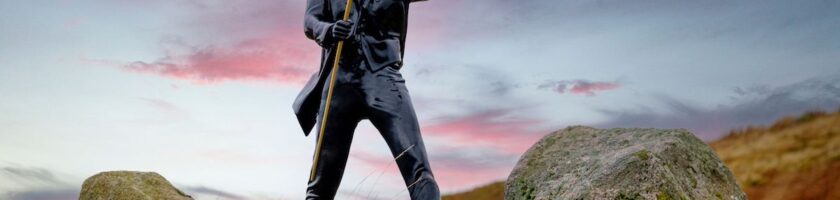 Promotional statue of Johnnie Walker Striding Man in outdoor mountain setting