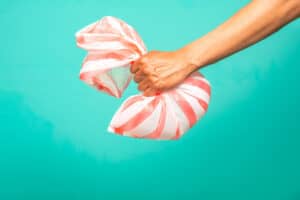 Image of hand grabbing plastic bag — bringing flexi back to be recycled