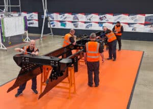 Workers in R&D setting constructing Volta Zero truck chassis.