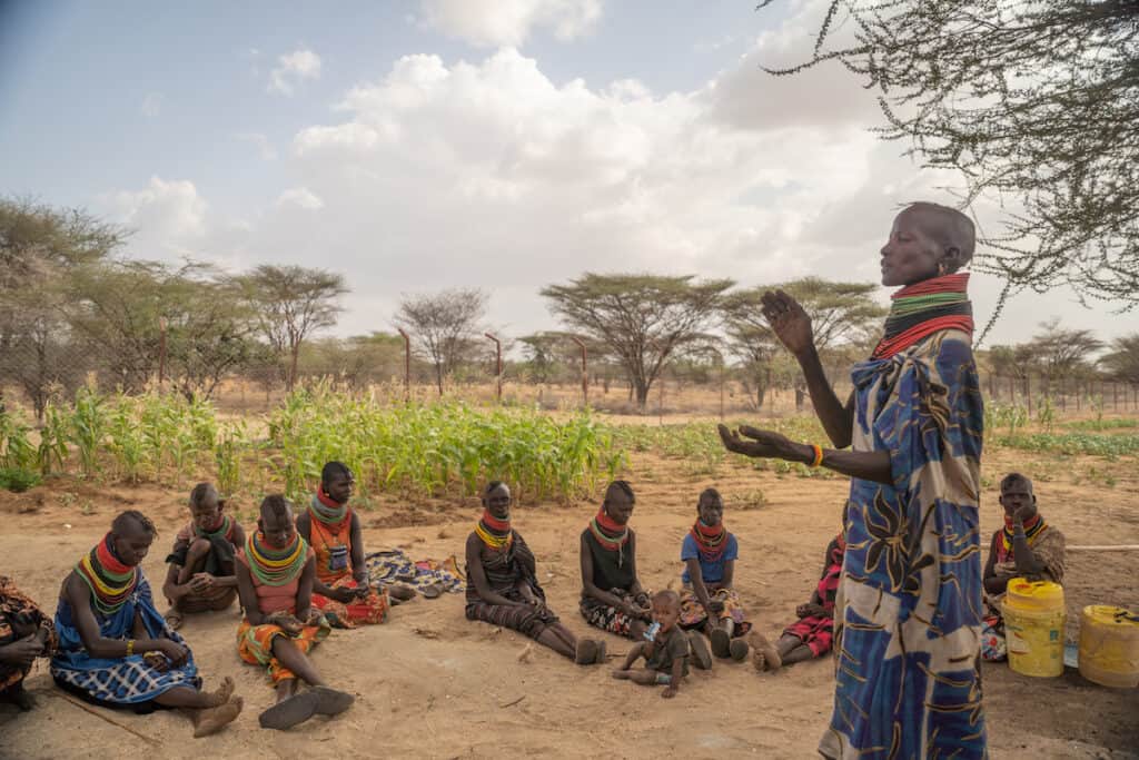 Lokutan Amaler (standing) speaks to fellow farmers (sat on ground) in Kangirega Village, Turkana County, on 23rd March 2022 copy
