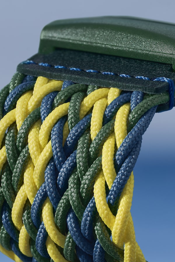 Close up of woven 100% recycled-plastic textile strap in yellow, blue and green, on Skagen Samsø Series watch SKW6881.
