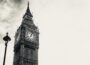 Black and white shot of clock tower housing Big Ben at Houses of Parliament, London.