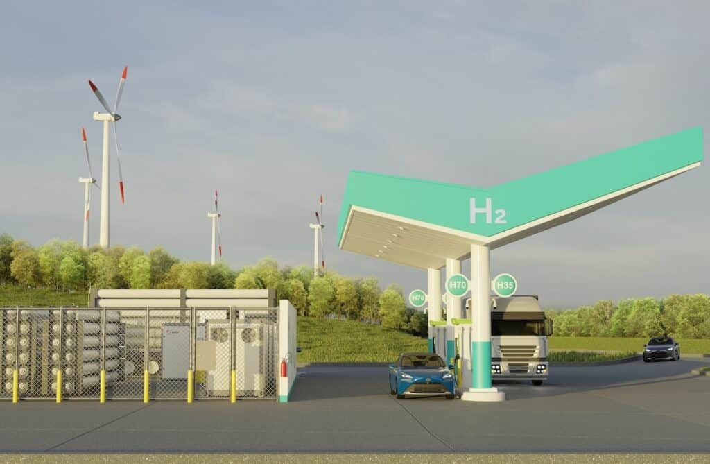 Side-view illustration of hydrogen refuelling station showing installation to left, H2 in white on green canopy, plus car and lorry in position for scale.