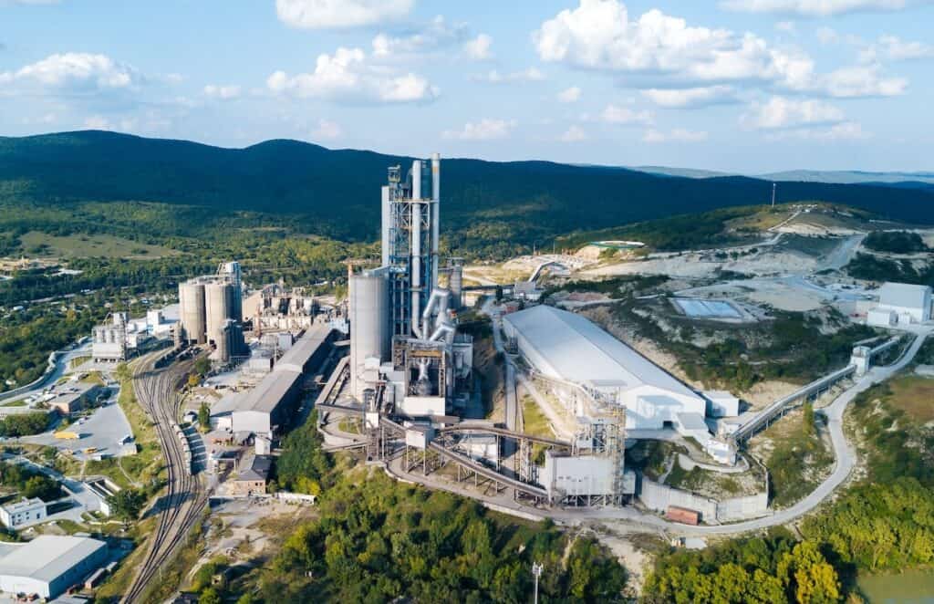 Aerial view of cement manufacturing plant, showing concept of buildings at the factory, steel pipes, giants.