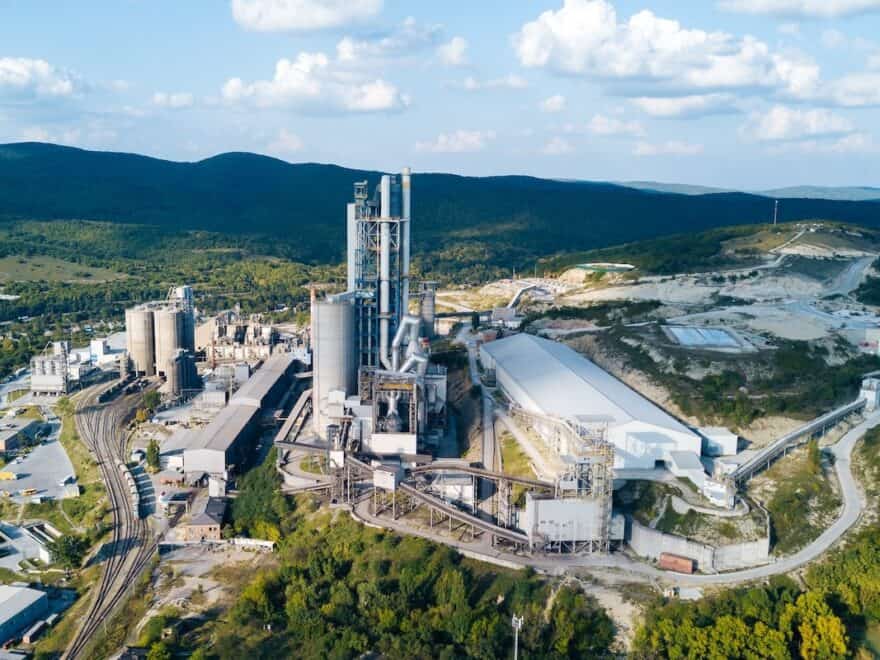 Aerial view of cement manufacturing plant, showing concept of buildings at the factory, steel pipes, giants.