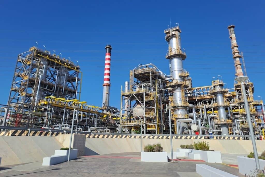 Industrial facility shot against blue sky shows Cepsa Química's Puente Mayorga plant, in Cádiz, Spain.