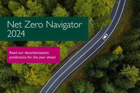Front cover of Net Zero Navigator 2024, showing report title, plus invitation to 'Read our decarbonisation predictions for the year ahead', in text boxes over aerial image of lone white car on road winding through forest.