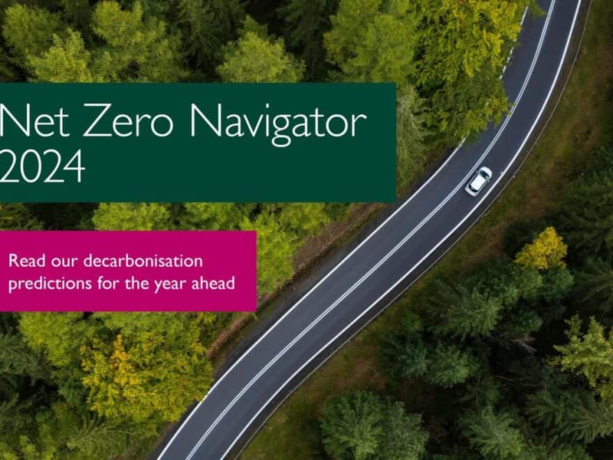 Front cover of Net Zero Navigator 2024, showing report title, plus invitation to 'Read our decarbonisation predictions for the year ahead', in text boxes over aerial image of lone white car on road winding through forest.