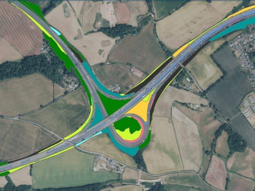 Aerial view of major road intersection in rural location, with bright yellow, green and blue highlights beside highways to show new data overlay.