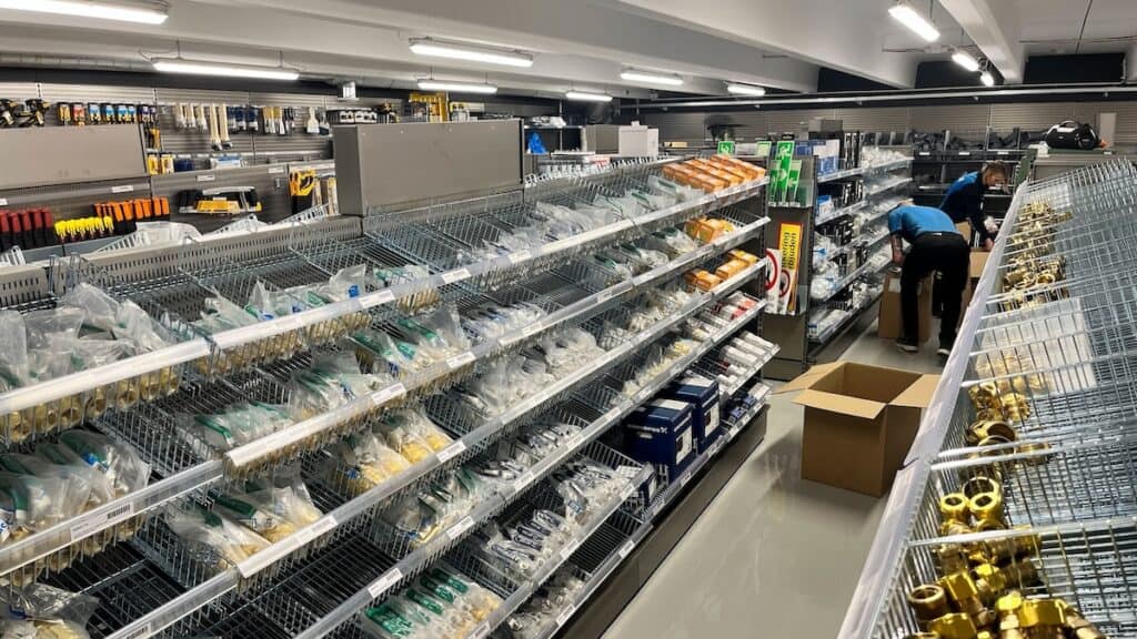 Shelving in retail unit, full of hardware and tools.