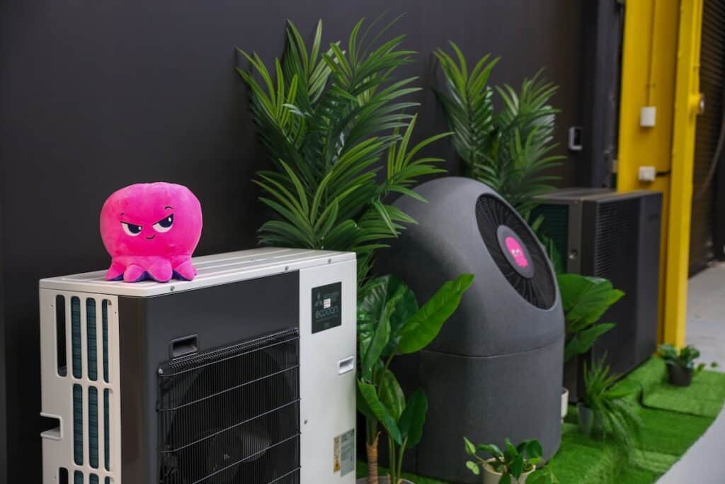 Example of heat pump technology pictured in commercial building setting (with pink Octopus brand soft toy on top).