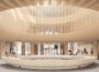 Exposed ribbed wooden structure creates circular atrium feature above equally large ring-shaped furniture piece in lobby area.