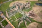 Aerial view of land art installation in and around ruins of Whitby Abbey, with hands drawn holding roots of tree in natural earth greens and browns.