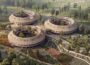 Visualisation of Almanakken project by Sweco Architects shows three ring-shaped building structures set within a regenerative green neighbourhood.