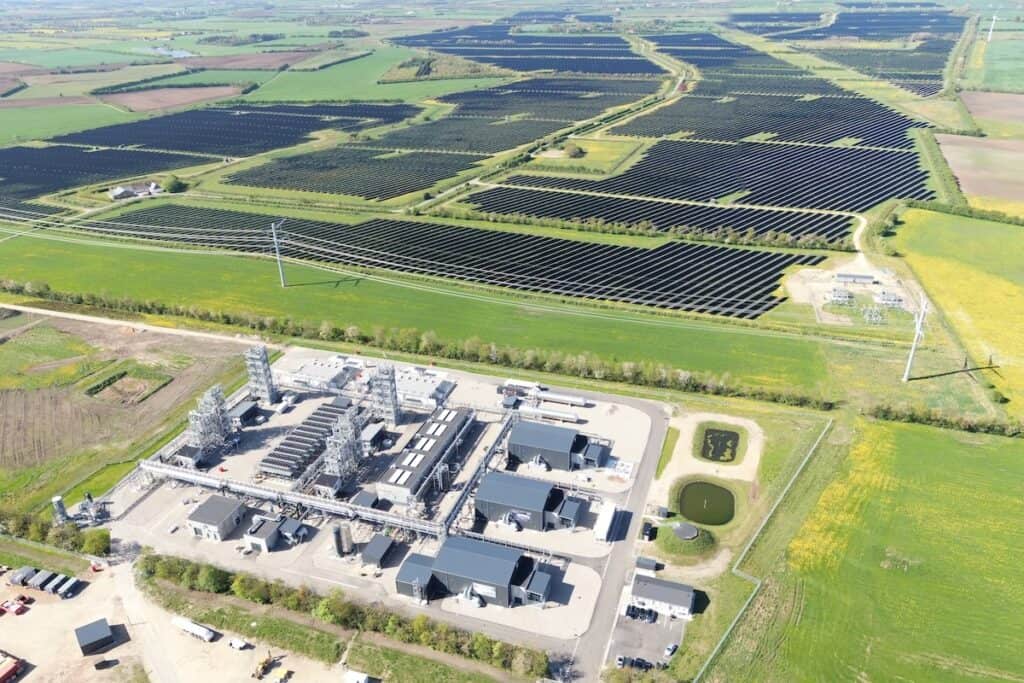 Aerial view of e-methanol production facility, set in countryside, with Europe's largest solar park stretching out across multiple fields above.
