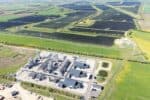 Aerial view of e-methanol production facility, set in countryside, with Europe's largest solar park stretching out across multiple fields above.
