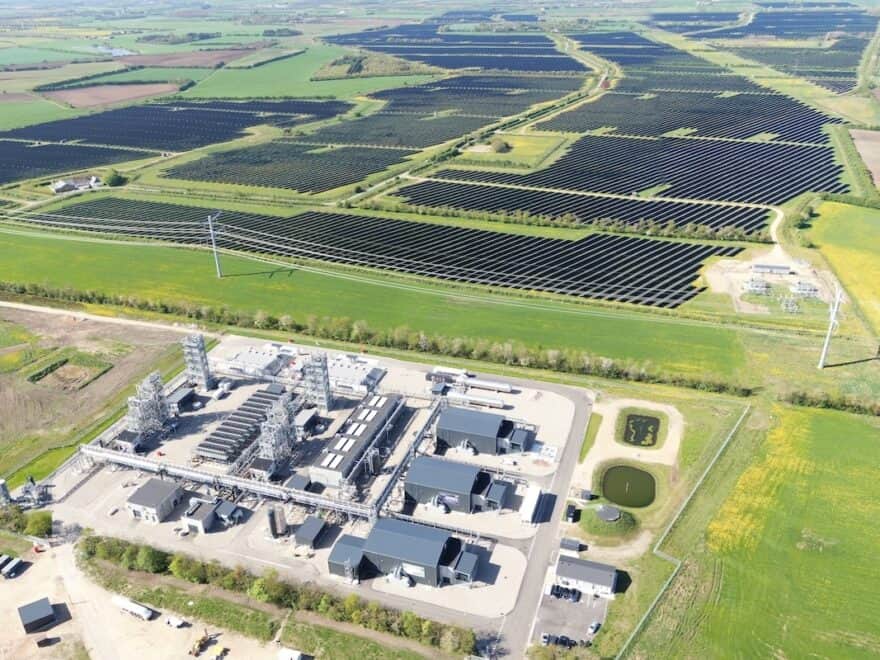 Aerial view of e-methanol production facility, set in countryside, with Europe's largest solar park stretching out across multiple fields above.