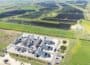 Aerial view of e-methanol production facility, set in countryside, with Europe's largest solar park stretching out across multiple fields above.