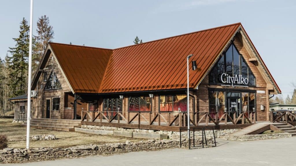 Mock-up of timber CityAlko store with solar roof in Copper Brown to match colour palette of traditional terracotta red tiles.