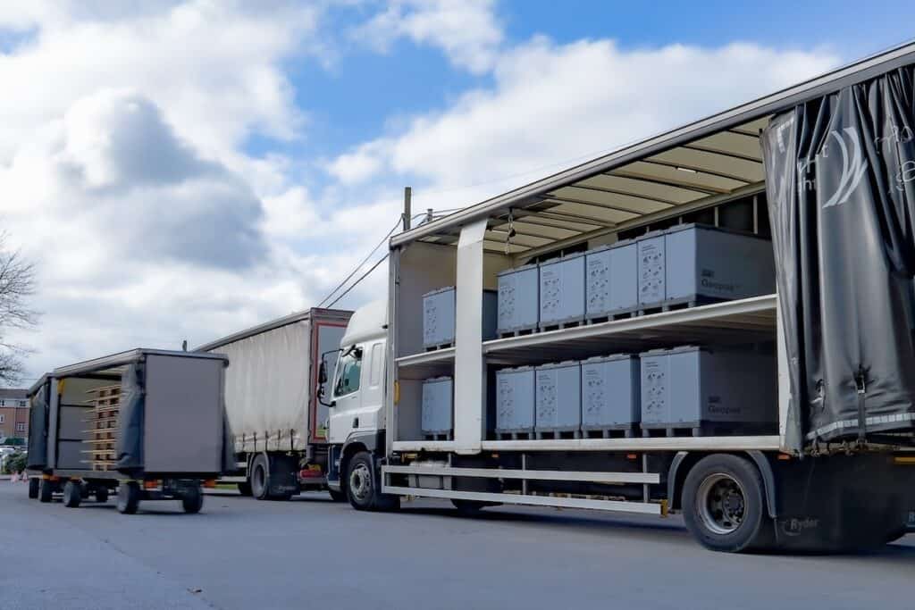 Whitecroft Lighting delivery vehicle shown with curtain wall pulled back to reveal full load of Geopack tote boxes.