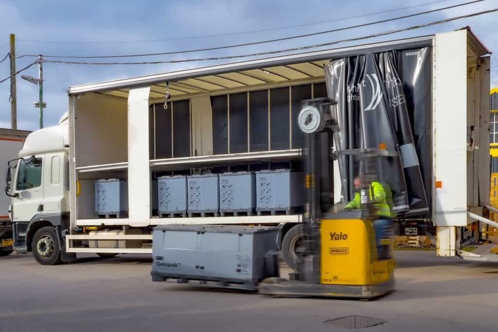 Whitecroft Lighting delivery vehicle shown part full with Geopack tote boxes, plus another on a yellow forklift in foreground.