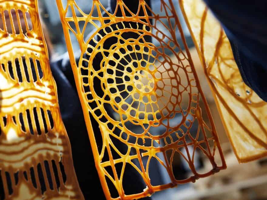 Close-up of yellow and brown spiral latticework design in sunlight.