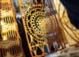 Close-up of yellow and brown spiral latticework design in sunlight.
