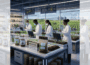 Square ChatGPT of scientists in lab coats, standing at benches with tech screens, surrounded by soil samples and plant incubators, crop fields visible through window behind; faded duplicate 25% panels L & R.
